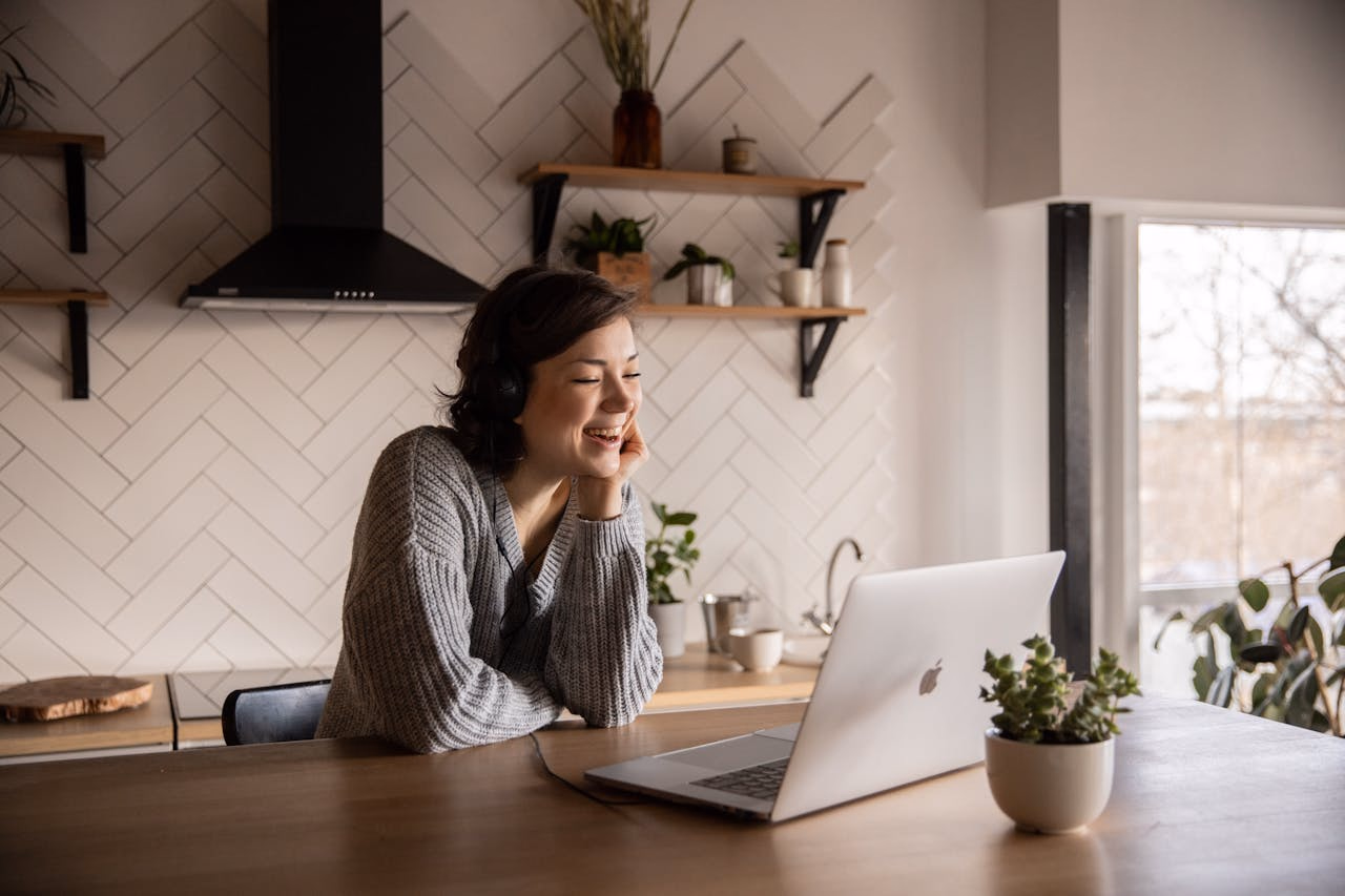 Woman relaxed on a couch after a psychiatric appointment, laptop closed beside her